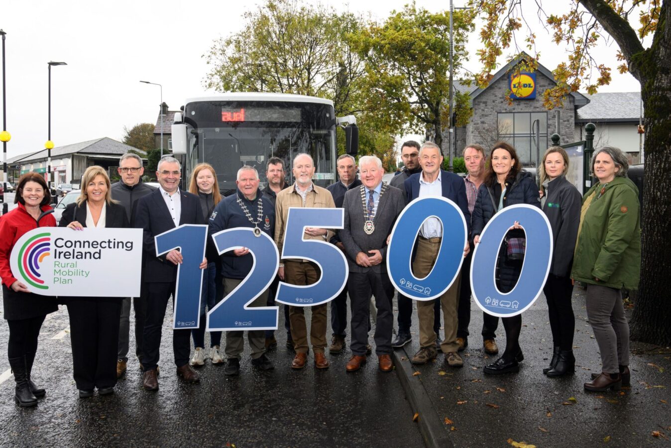 Lift to Right
Deirdre Finnerty, Head of Community Engagement Mayo County Council/Director TFI Local Link Mayo.
Rose Conway Walsh TD, 
John Doyle, Contracts Administrator, TFI Local Link mayo
Dara Calleary TD Minister of State for Trade Promotion, Digital and Company Regulation.
Aoife Brennan, Logistics, Corduff Travel
Cllr Michael Loftas
Martin Hyland – Head Mechanic, Corduff Travel
Declan Turnbull, Head of Ballina MD and Chairperson TFI Local Link Mayo
Declan Ginnelly, Executive Engineer, Ballina MD
An Cathoirleach John O’Hara, Mayo County Council
Michael Corduff, Managing Director, Corduff Travel
Michael Holmes, Director, TFI Local Link Mayo
Thomas Bibby, Transport Planner, National Transport Authority
Sarah Togher, Manager, TFI Local Link Mayo
Jennifer Corcoran, Transport Co-ordinator, TFI Local Link Mayo
Orla Bourke – Senior Executive Engineer, Ballina Municipal District (MD)