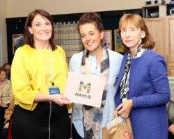 Local Link Mayo host National Age Friendly Recognition and Achievement Judges at an event in the Father Peyton Centre, Attymass. Pictured at the event are Sarah Togher, Manager Mayo Local Link. , making a presentation of Mayo.ie catalogue to Syliva McCarthy, Age Friendly Ireland and Bernie O'Brien, Age Friendly Ireland, . Pic: Heverin Print. Sarah Togher presenting to Syliva McCarthy and Bernie O'Brien.