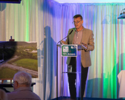 Dominic Hannigan giving speech on the stage